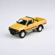 Load image into Gallery viewer, 1:64 1984 Toyota Hilux Single Cab Yellow / Red
